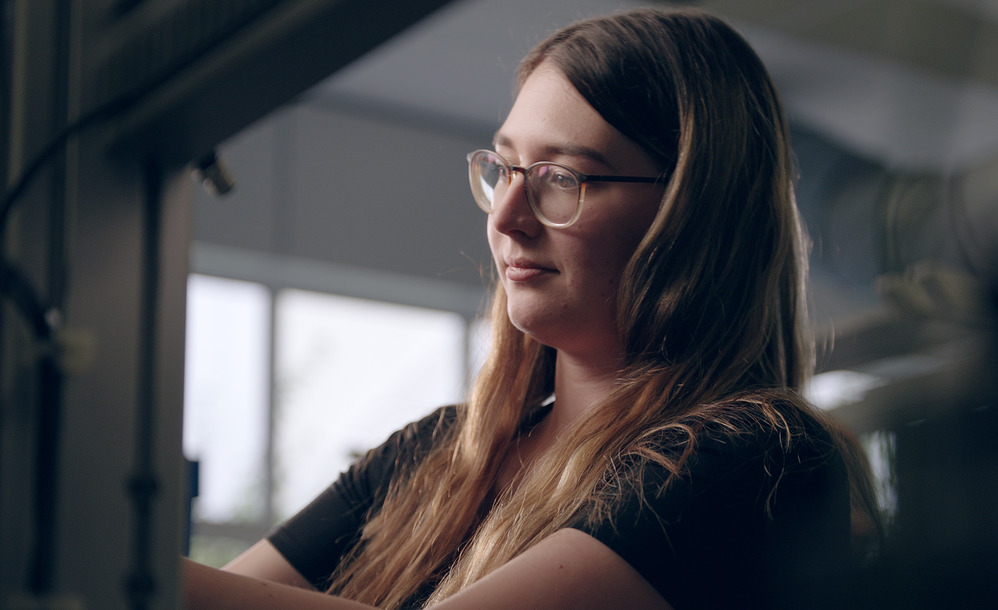 Young Woman Focused at Work.webp