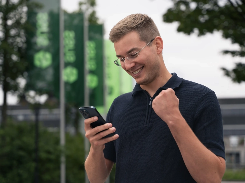 Cheerful Man Looking at Phone