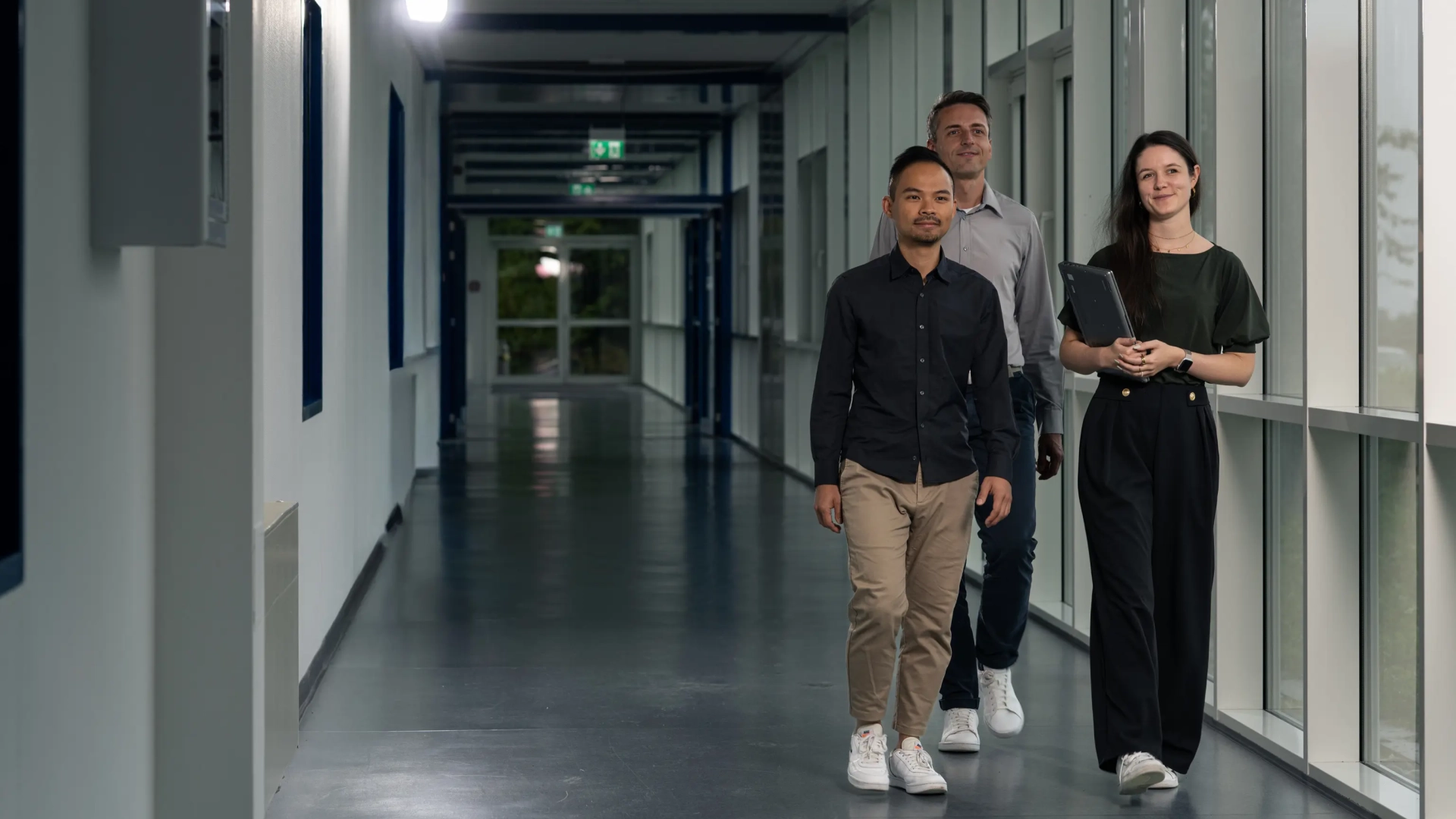 Employees Walking in Corridor