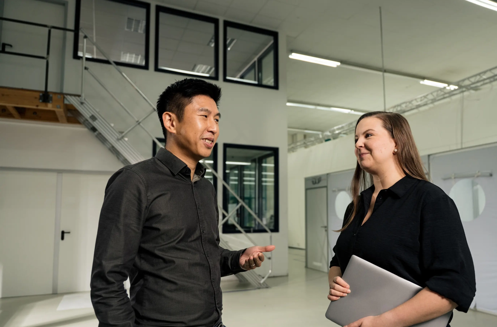 Man and Woman with Laptop Talking