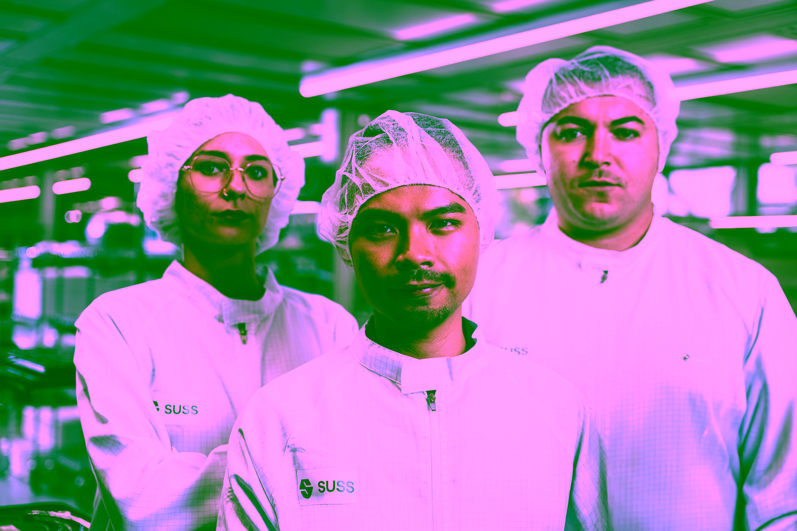 Three people in semiconductor production cleanroom