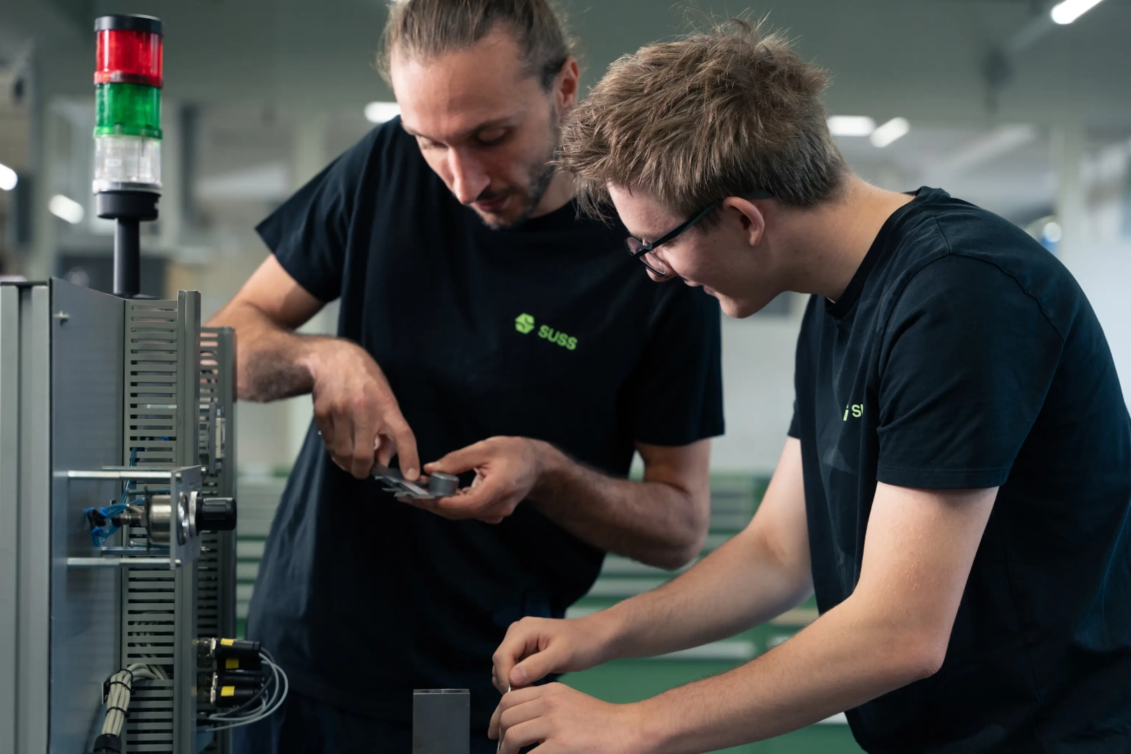 Two Young Men Checking Machine Parts