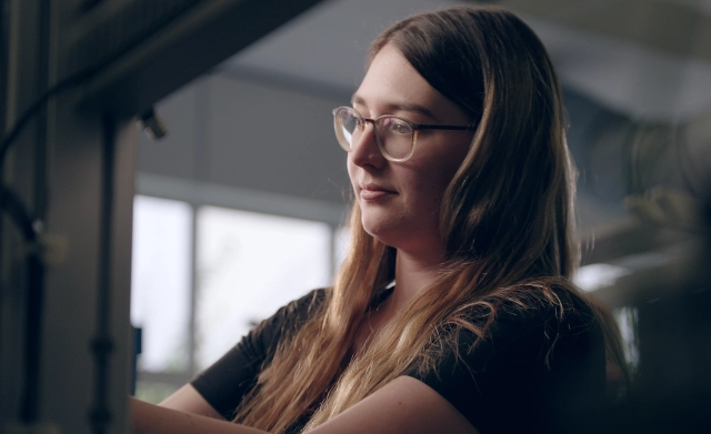 Young Woman Focused at Work.webp